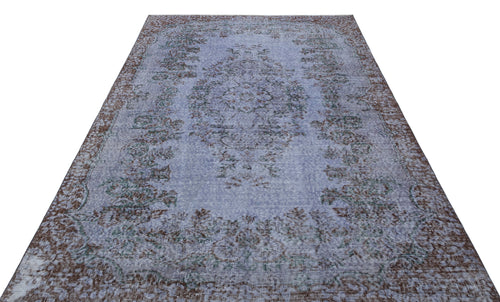 Load image 1 in gallery view. Distressed periwinkle blue rug with a brown and teal traditional floral medallion pattern on a white background.