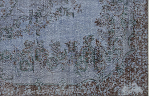Load image 1 in gallery view. Distressed blue and brown rug with a faded floral medallion pattern on a white background.