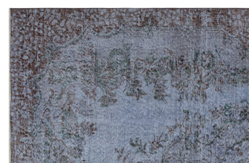 Load image 1 in gallery view. Blue and brown distressed rug with a faded traditional floral medallion pattern.