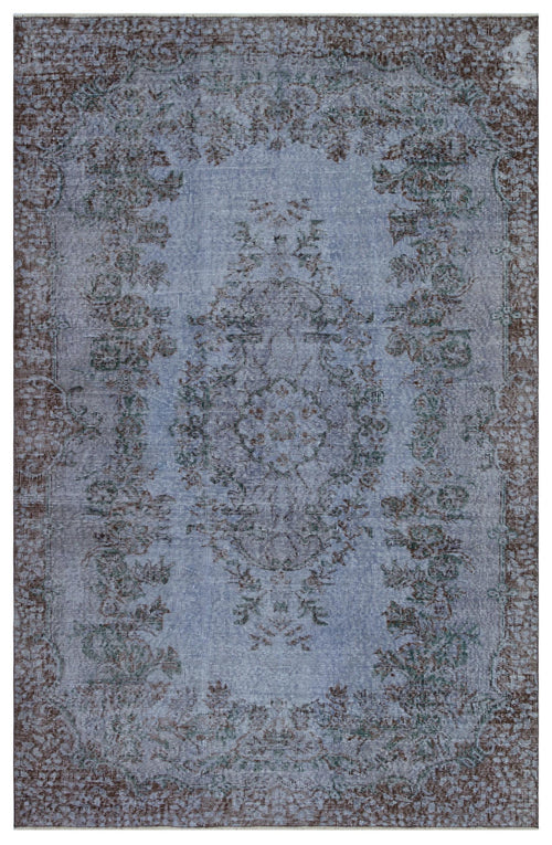 Load image 1 in gallery view. Distressed blue and brown traditional rug with a central floral medallion and ornate border.