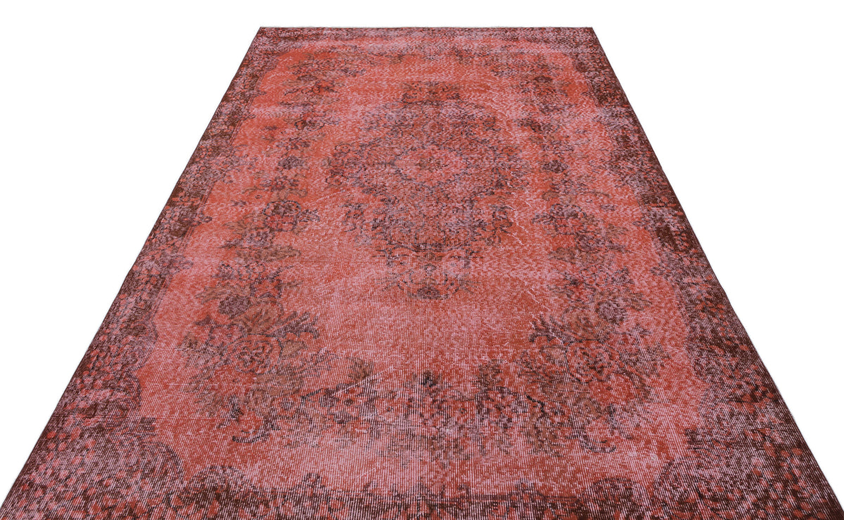 Distressed red and dark brown traditional rug with a central floral medallion and ornate border.