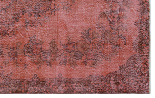 Load image 1 in gallery view. Terracotta and dark brown distressed rug with a faded floral medallion pattern.
