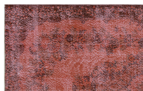 Load image 1 in gallery view. Distressed terracotta and dark brown rug with a faded floral medallion pattern.
