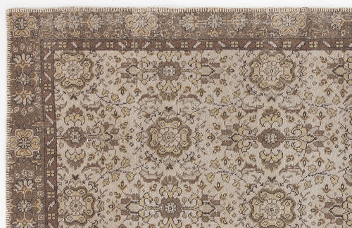 Load image 1 in gallery view. Distressed brown and beige rug with a traditional floral medallion pattern and a wide decorative border.