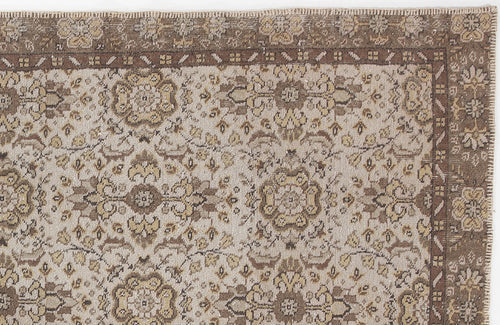 Load image 1 in gallery view. Beige and brown traditional rug with a distressed floral medallion pattern and a wide decorative border.