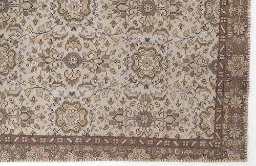 Load image 1 in gallery view. Beige and brown traditional rug with a repeating floral medallion pattern and a wide, detailed border.