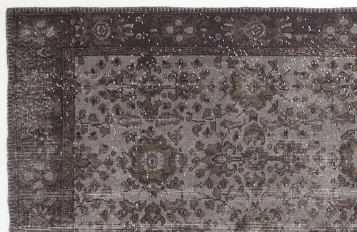Load image 1 in gallery view. Dark charcoal and grey distressed rug with a traditional floral medallion pattern and a stitched border.