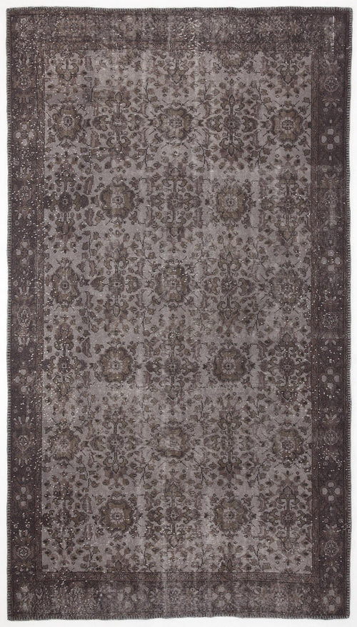 Load image 1 in gallery view. Dark charcoal and grey distressed rug with a traditional floral medallion pattern and a wide decorative border.
