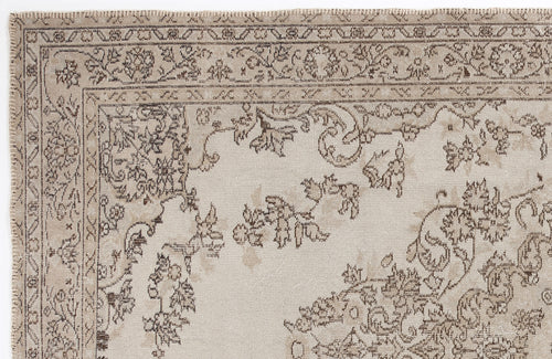 Load image 1 in gallery view. Beige and taupe rug with a traditional floral medallion border and distressed botanical pattern.