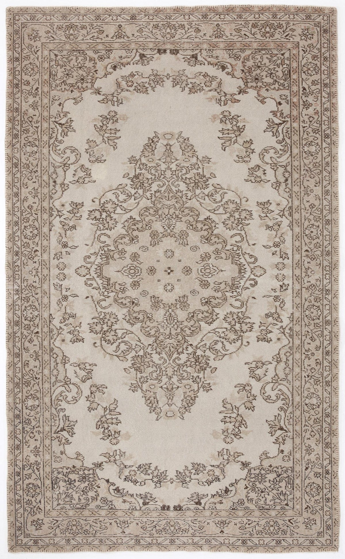 Beige and taupe traditional area rug with a central floral medallion and intricate border pattern on a white background.