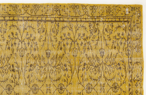 Load image 1 in gallery view. Mustard yellow and brown distressed rug with a traditional floral vine pattern and a bordered edge.