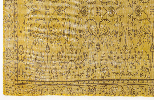 Load image 1 in gallery view. Mustard yellow distressed rug with a brown floral medallion pattern and a decorative border.