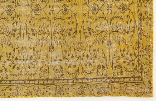 Load image 1 in gallery view. Mustard yellow distressed rug with a dark brown floral vine pattern and a geometric border.
