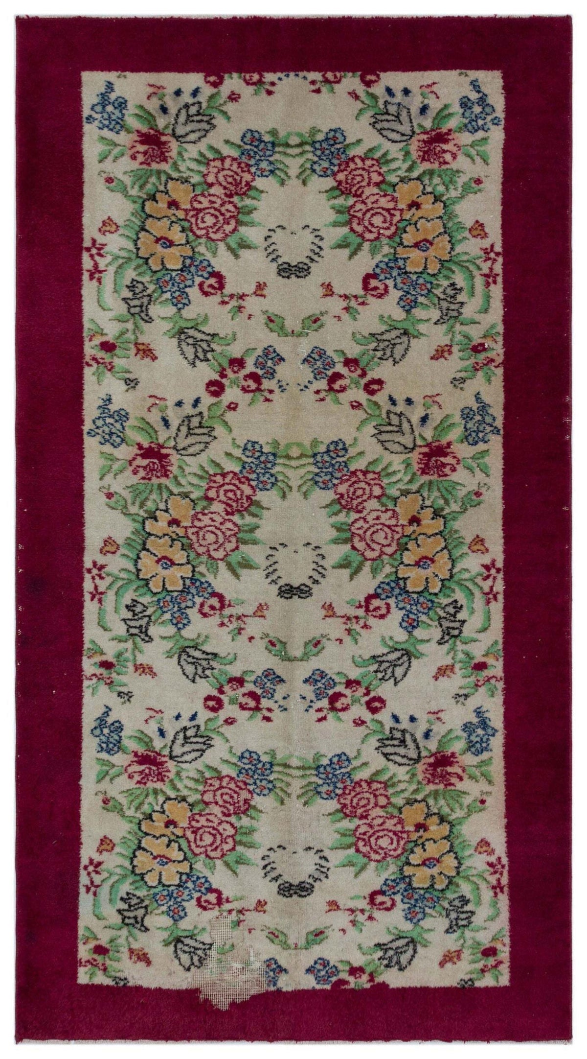 Cream runner rug with a deep red border and a repeating floral pattern in pink, yellow, blue, and green.