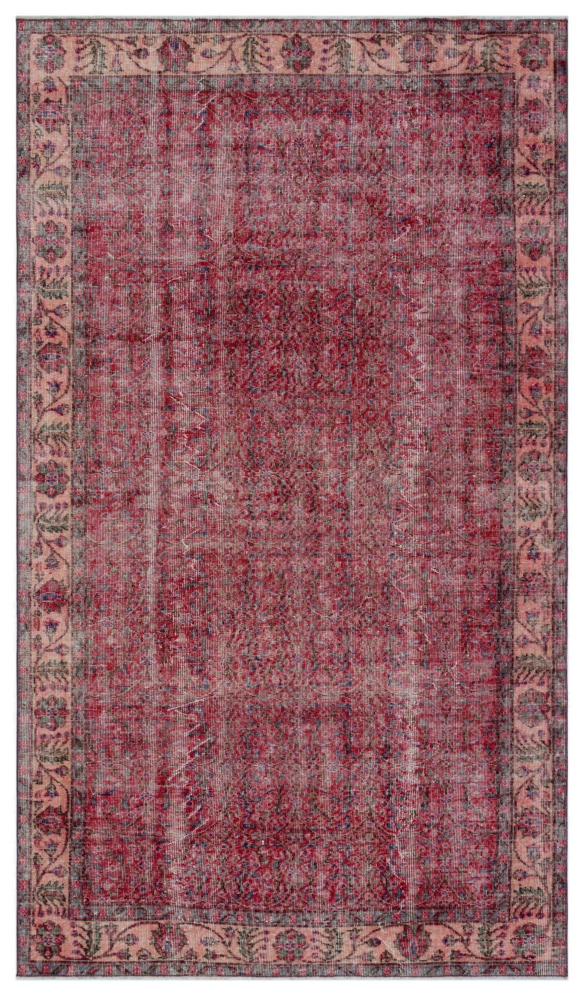 Distressed red and pink traditional rug with a faded floral border and intricate central medallion pattern.