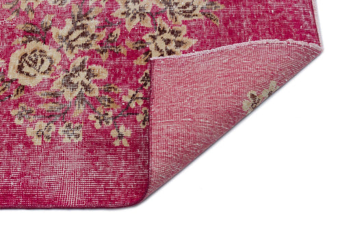 Load image 1 in gallery view. Magenta and beige floral distressed rug with a corner folded over to show the woven backing.