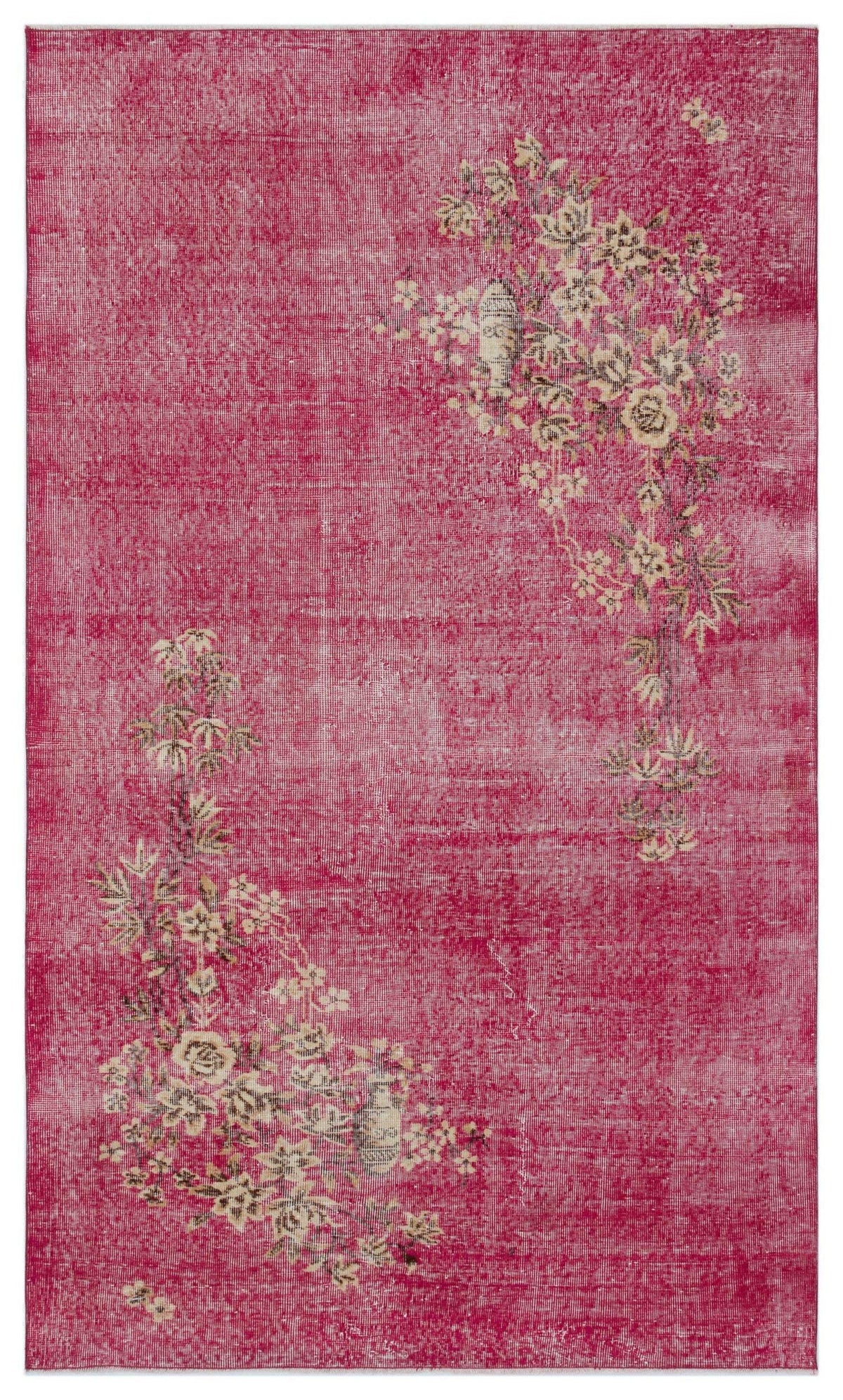 Fuchsia distressed rug with cream and olive floral branch motifs in opposite corners.
