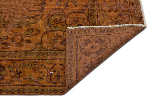 Load image 1 in gallery view. Rust and brown vintage-style rug with a traditional floral medallion pattern and a folded corner on a white background.
