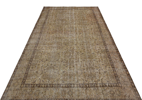 Load image 1 in gallery view. Distressed brown and tan vintage-style rug with a faded floral medallion pattern and a wide decorative border.