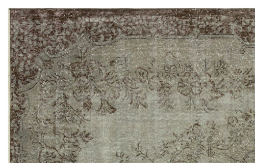 Load image 1 in gallery view. Distressed brown and taupe rug with a faded floral medallion pattern and a wide decorative border.