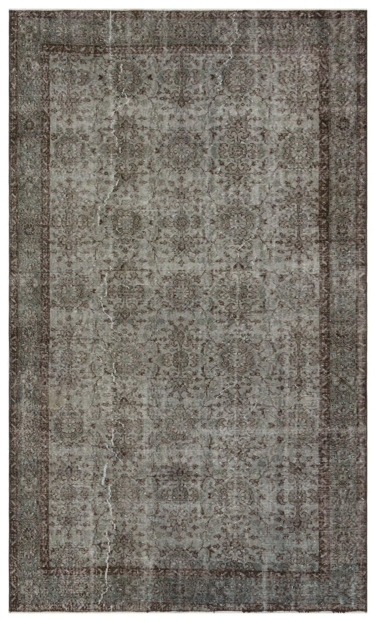 Grey and brown distressed traditional rug with a faded floral medallion pattern and a dark border.