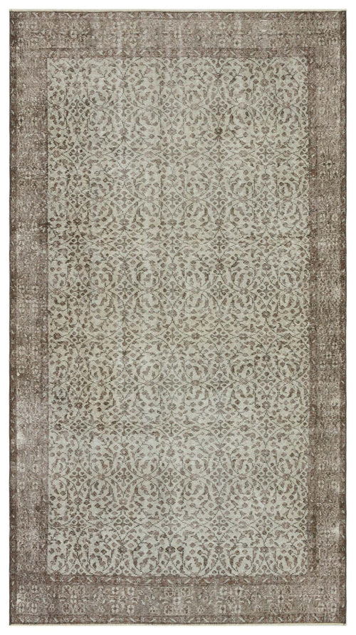 Load image 1 in gallery view. Taupe and cream distressed rug with a traditional repeating floral medallion pattern and a wide border.