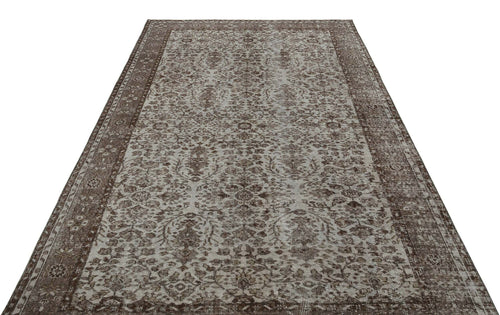 Load image 1 in gallery view. Brown and grey distressed traditional rug with an intricate floral medallion pattern and a wide border.