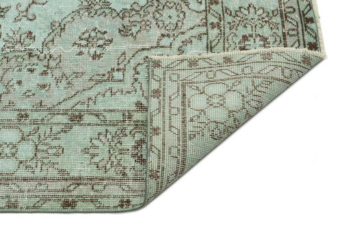 Load image 1 in gallery view. Light blue and brown traditional floral medallion rug with a folded corner on a white background.
