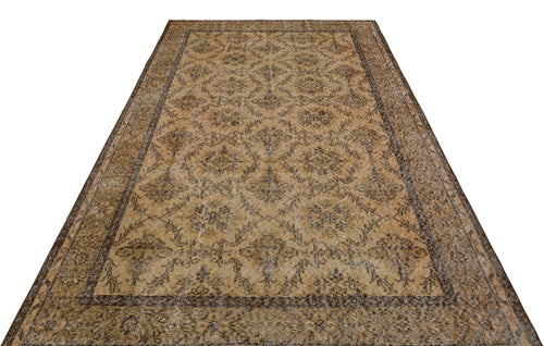 Load image 1 in gallery view. Tan and brown vintage-style rug with a distressed floral medallion pattern and a wide decorative border.