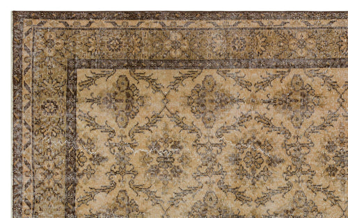 Load image 1 in gallery view. Tan and dark brown traditional rug with a distressed floral medallion pattern and a wide decorative border.