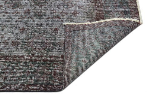 Load image 1 in gallery view. Distressed grey and burgundy vintage-style rug with a floral medallion pattern, shown with a corner folded over.