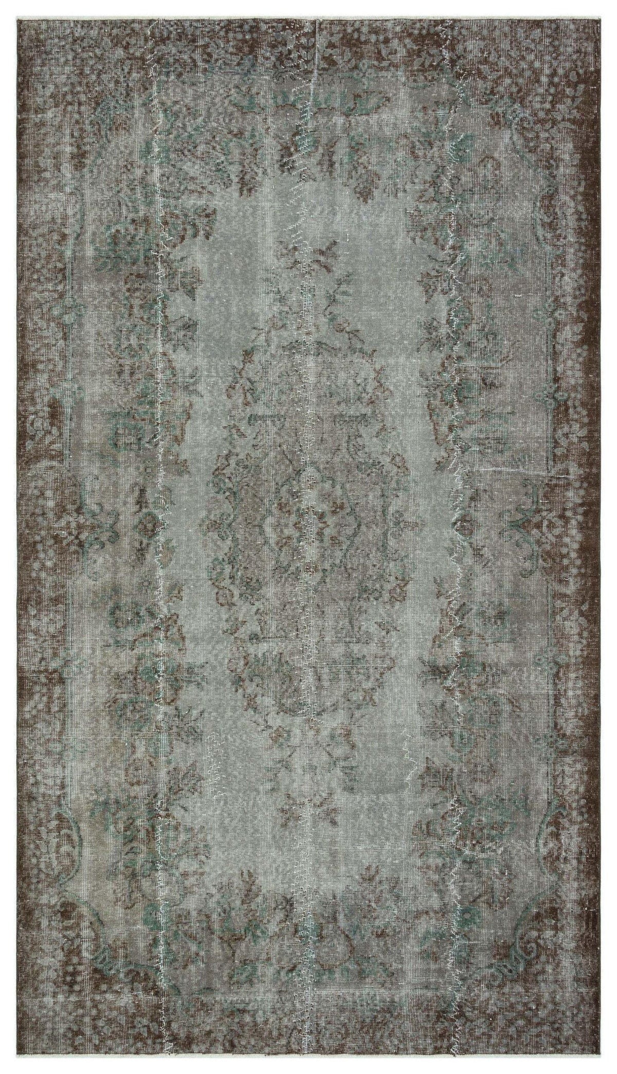 Distressed grey and brown vintage-style rug with a central floral medallion and ornate border.
