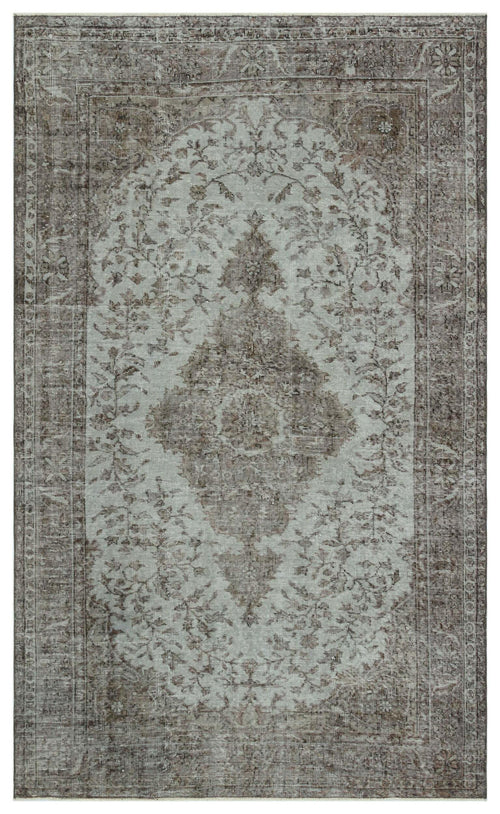 Load image 1 in gallery view. Distressed sage green and brown rug with a traditional central floral medallion and ornate border.