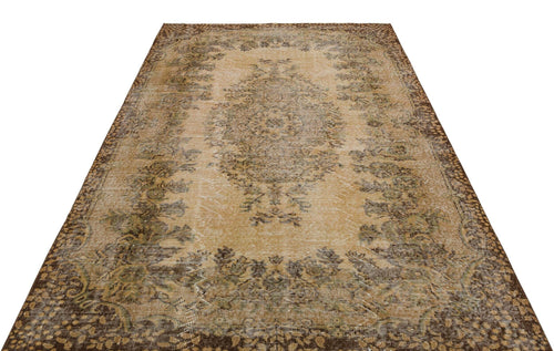 Load image 1 in gallery view. Distressed tan and brown vintage-style rug with a central floral medallion and ornate border on a white background.