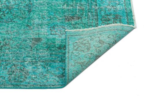 Load image 1 in gallery view. Teal and dark grey distressed medallion pattern rug with a folded corner showing the woven backing.