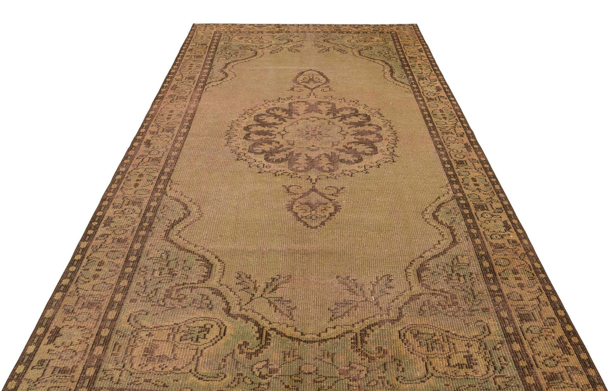 Distressed tan and brown vintage-style rug with a central medallion and ornate border pattern on a white background.