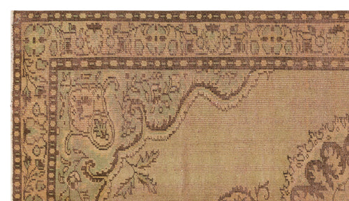 Load image 1 in gallery view. Tan and sage green vintage-style rug with a distressed traditional floral border and central medallion pattern.