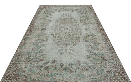 Load image 1 in gallery view. Distressed light blue and brown vintage-style rug with a central floral medallion and ornate border.