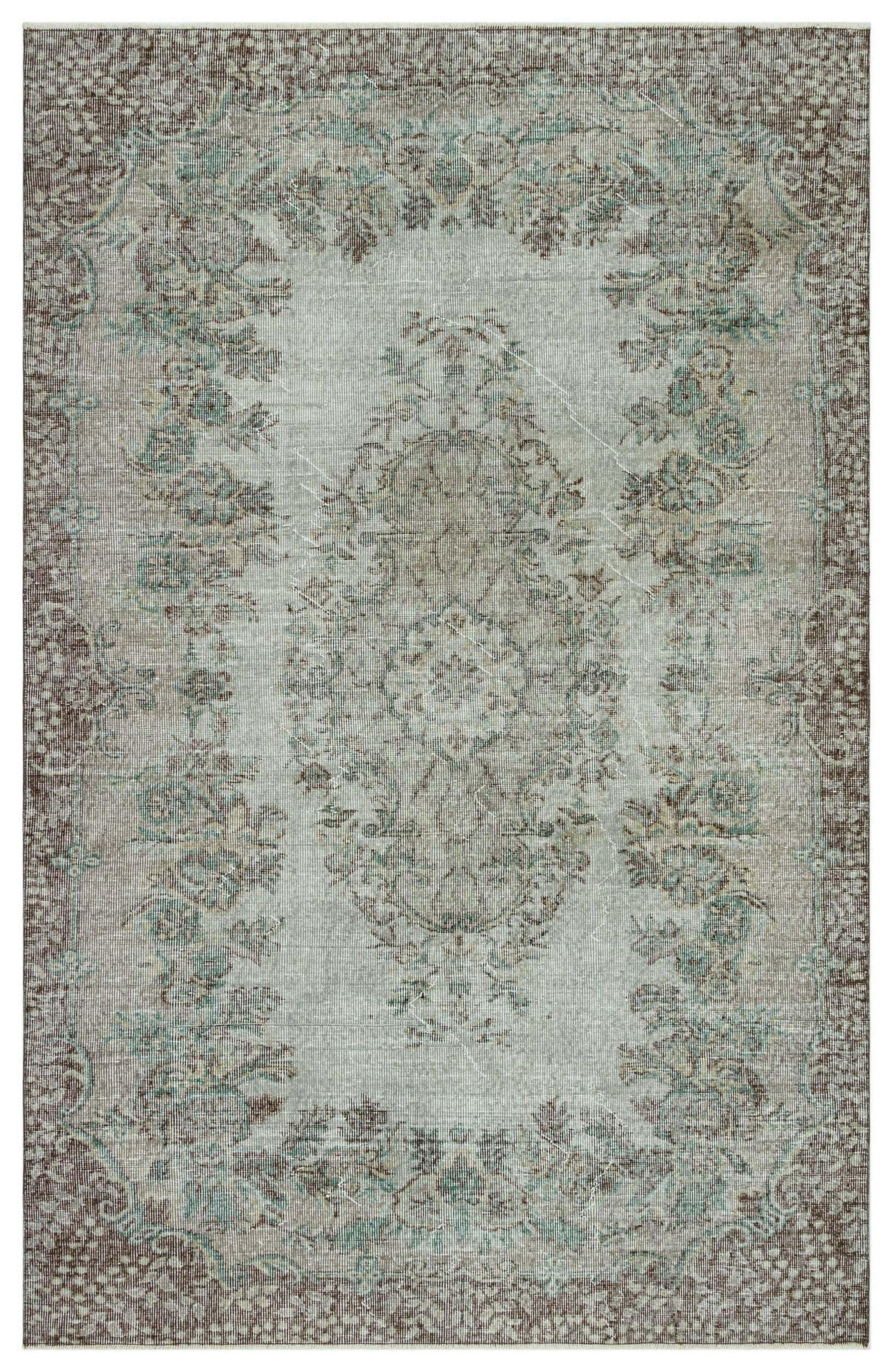 Distressed grey and brown traditional rug with a central floral medallion and ornate border.