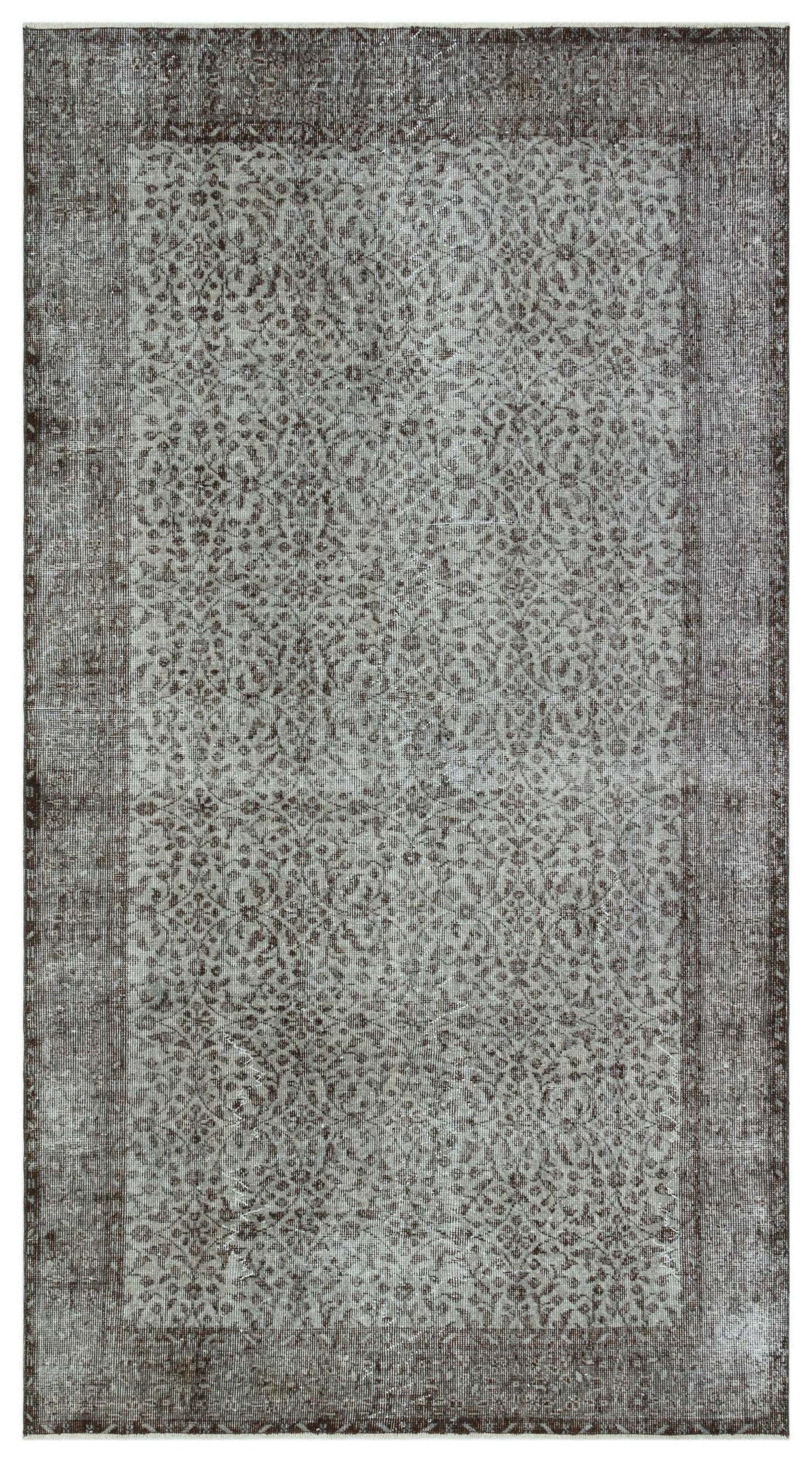 Charcoal and grey distressed rug with an intricate, repeating floral medallion pattern and a wide border.