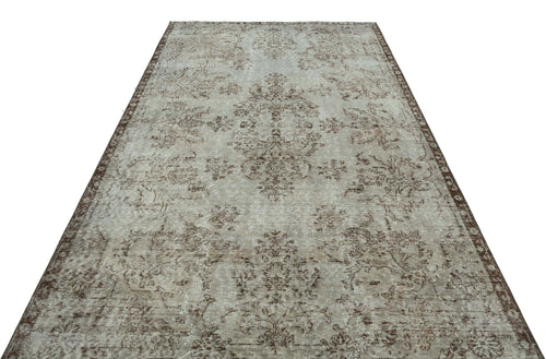 Load image 1 in gallery view. Light gray and brown distressed vintage-style rug with a central floral medallion and ornate border.