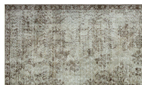 Load image 1 in gallery view. Taupe and brown distressed rug with a faded traditional floral medallion pattern.