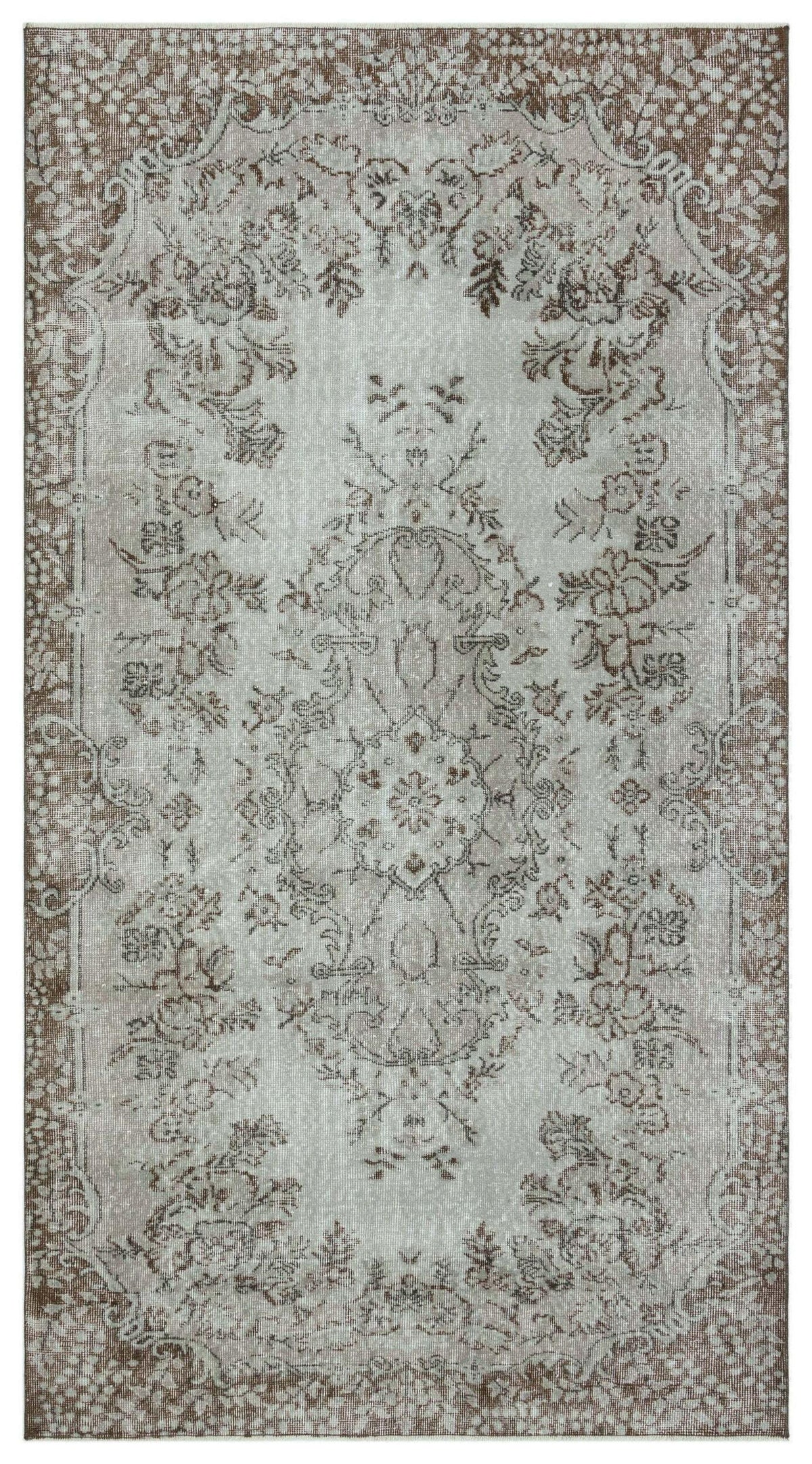 Light gray and brown distressed rug with a traditional floral medallion pattern and ornate border.