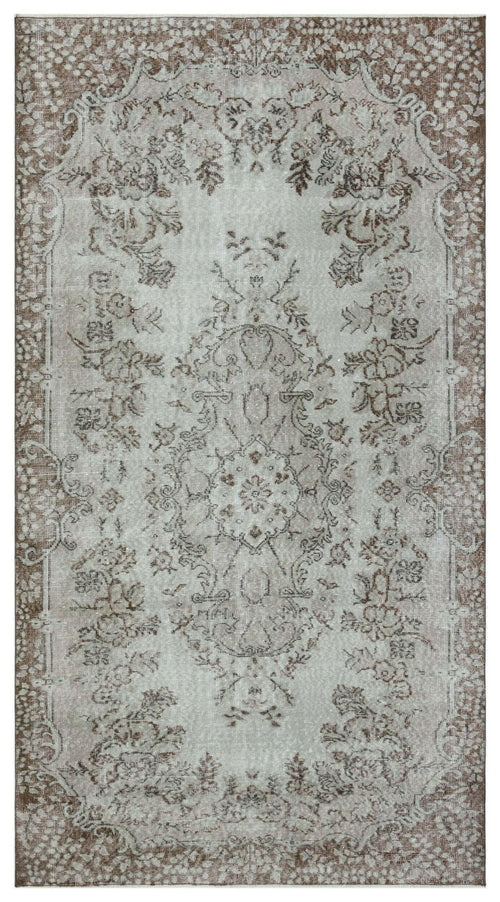Load image 1 in gallery view. Light gray and brown distressed rug with a traditional floral medallion pattern and ornate border.