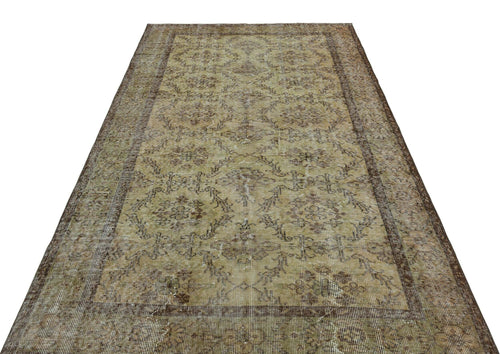 Load image 1 in gallery view. Distressed olive and brown vintage rug with a faded floral medallion pattern and a wide decorative border.