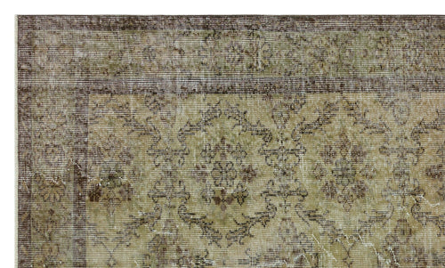 Load image 1 in gallery view. Distressed olive green and brown rug with a traditional floral medallion pattern and a wide decorative border.