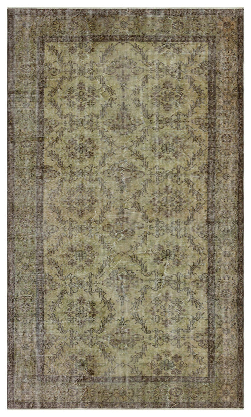 Load image 1 in gallery view. Olive green and brown distressed traditional rug with a repeating floral medallion pattern and a wide border.