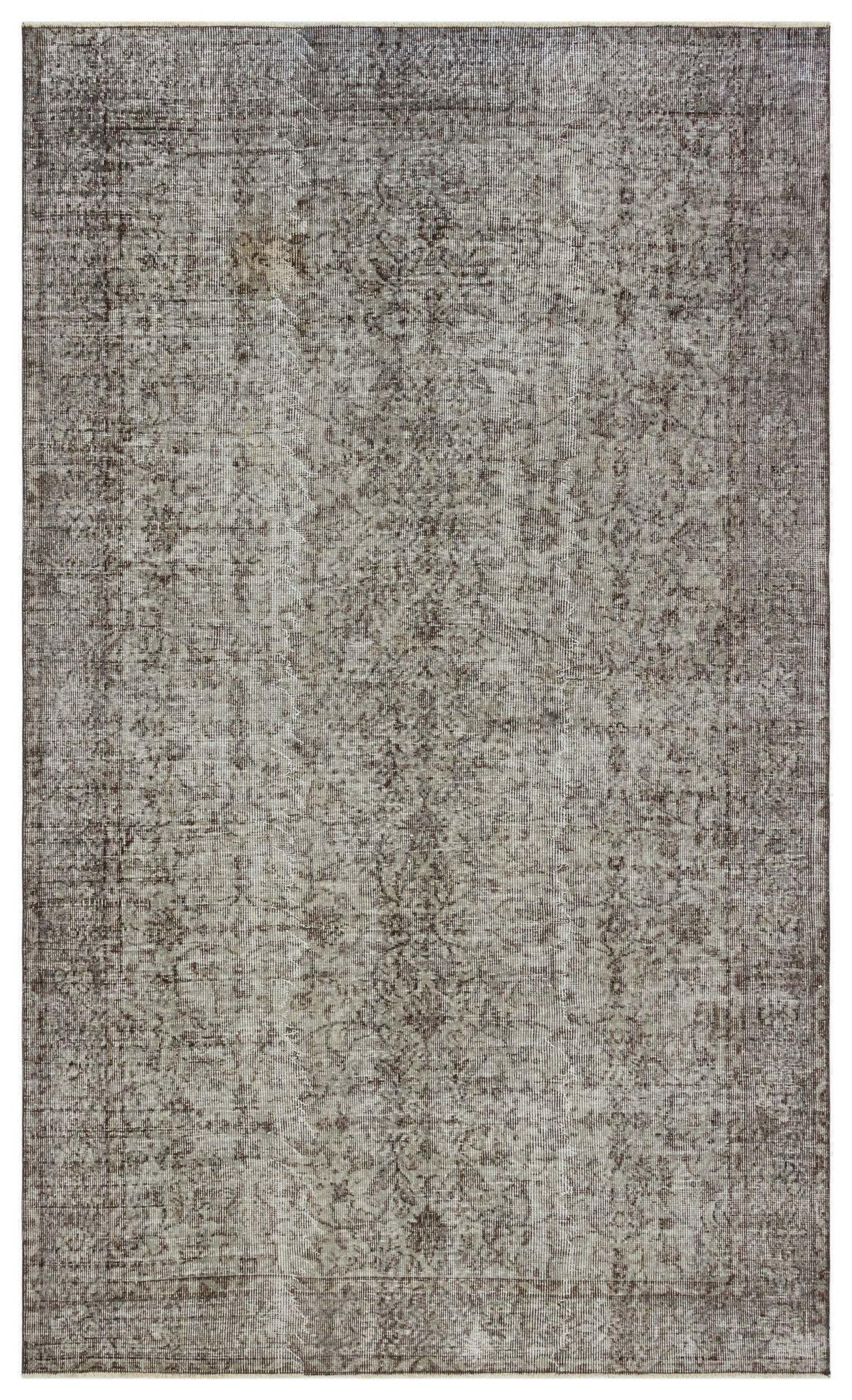 Distressed charcoal and grey rug with a faded traditional floral medallion pattern on a white background.