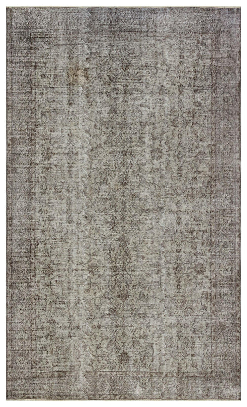 Load image 1 in gallery view. Distressed charcoal and grey rug with a faded traditional floral medallion pattern on a white background.