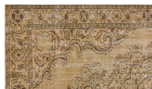 Load image 1 in gallery view. Tan and brown vintage-style rug with a distressed floral medallion border and ornate scrollwork pattern.